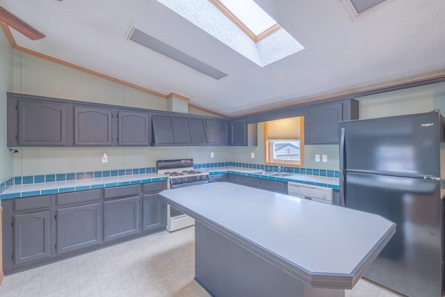 kitchen with sink, backsplash, white appliances, vaulted ceiling with skylight, and a kitchen island