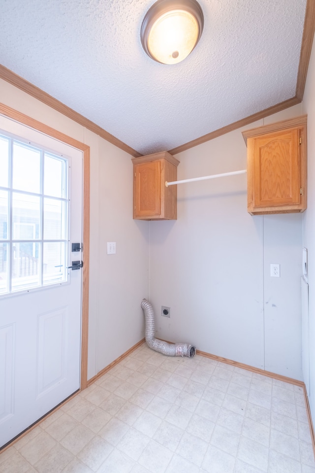 washroom featuring hookup for an electric dryer, crown molding, cabinets, and a textured ceiling