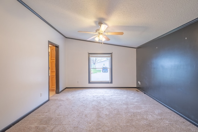 carpeted spare room with ceiling fan, ornamental molding, a textured ceiling, and vaulted ceiling