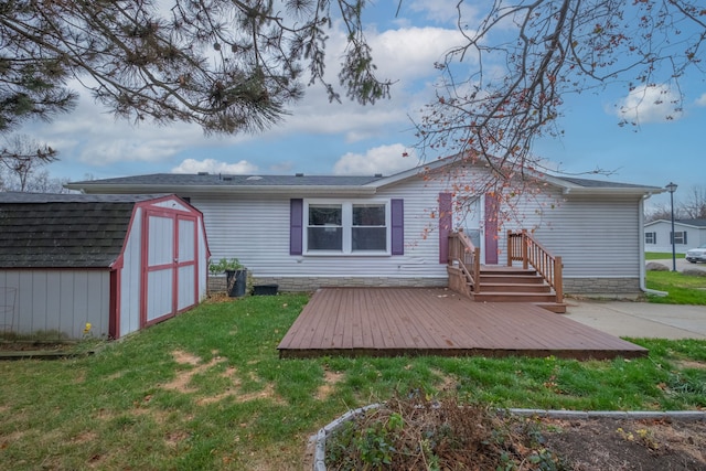 rear view of property with a storage unit, a deck, and a yard