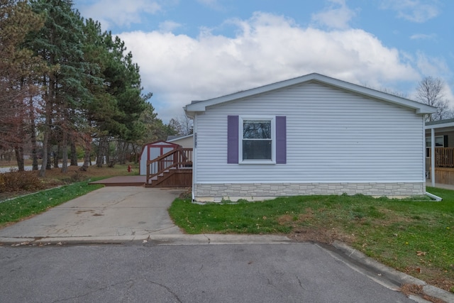 view of property exterior featuring a storage unit and a deck