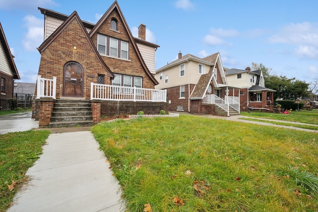 tudor-style house featuring a front yard