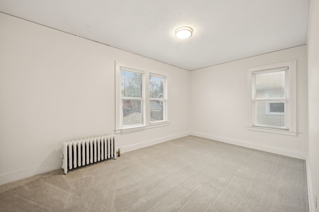 carpeted empty room with radiator