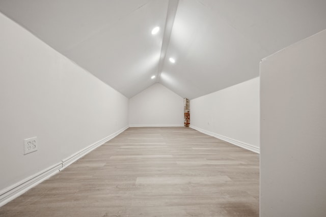 bonus room featuring lofted ceiling and light hardwood / wood-style flooring