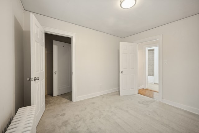 unfurnished bedroom featuring light carpet