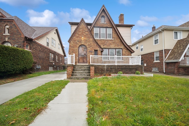 tudor home featuring a front yard