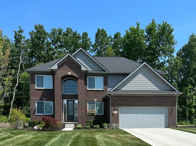 view of front of home with a garage and a front yard