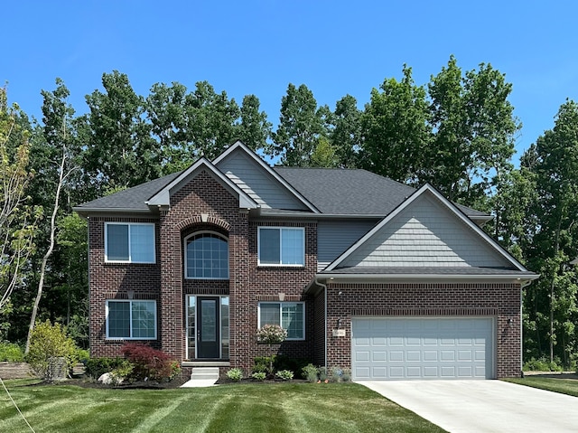 view of front of home with a garage and a front lawn