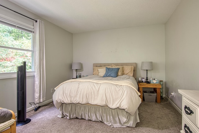 carpeted bedroom with a textured ceiling