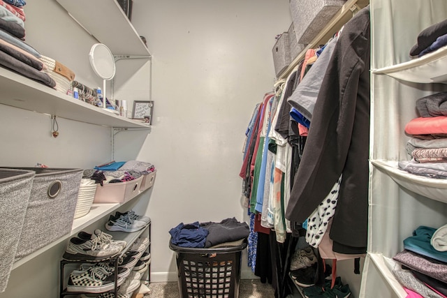 walk in closet with carpet floors