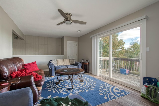 living room featuring ceiling fan and wood-type flooring