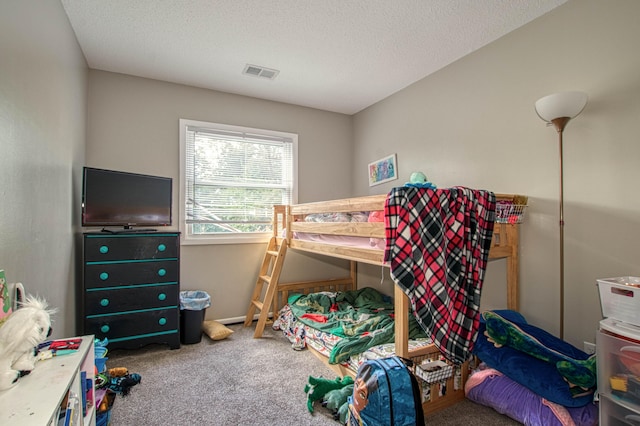 carpeted bedroom featuring a textured ceiling