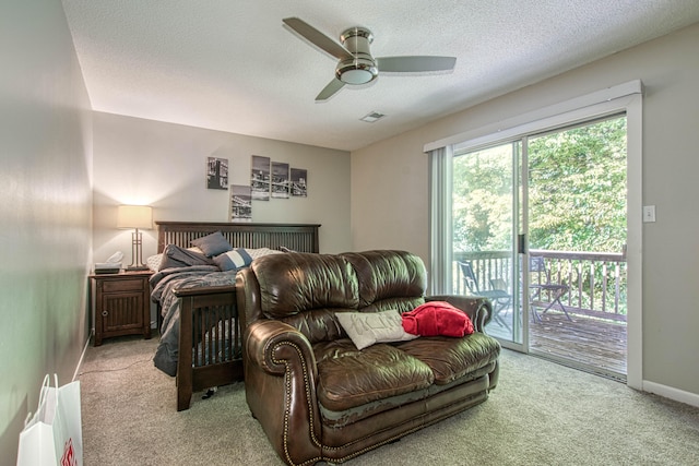 carpeted bedroom with ceiling fan, a textured ceiling, and access to outside