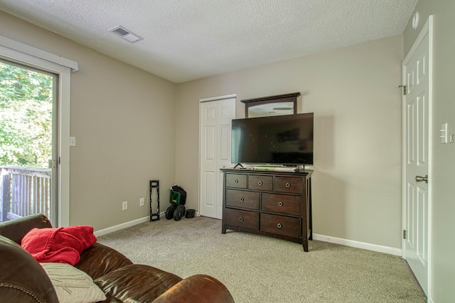 living room with light carpet and a textured ceiling