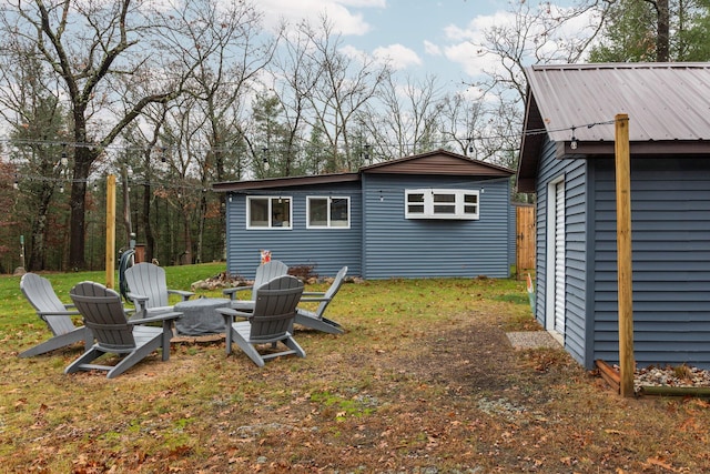 view of yard with a storage shed and an outdoor fire pit