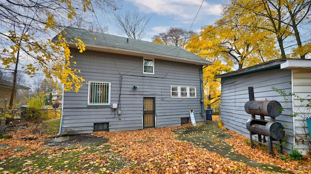 back of house with fence