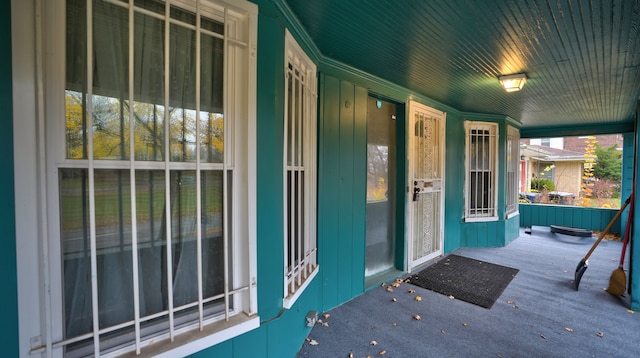 view of exterior entry featuring covered porch