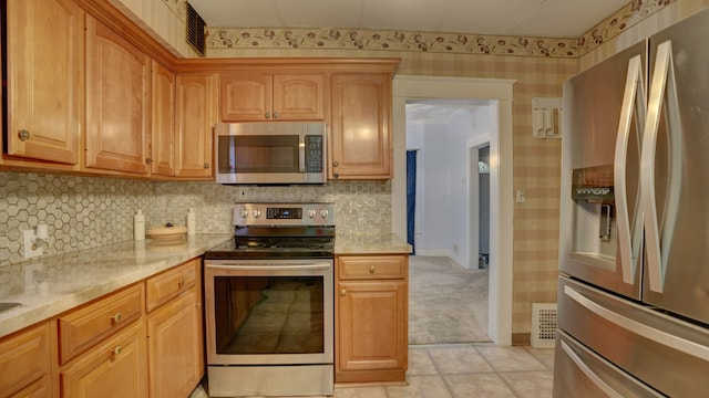 1644 Mason St, Flint, MI 48503 - kitchen with appliances with stainless steel finishes, backsplash, and wallpapered walls