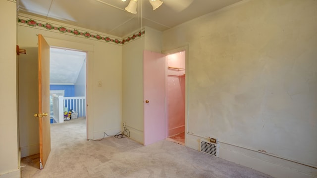 spare room with ceiling fan, ornamental molding, and light carpet