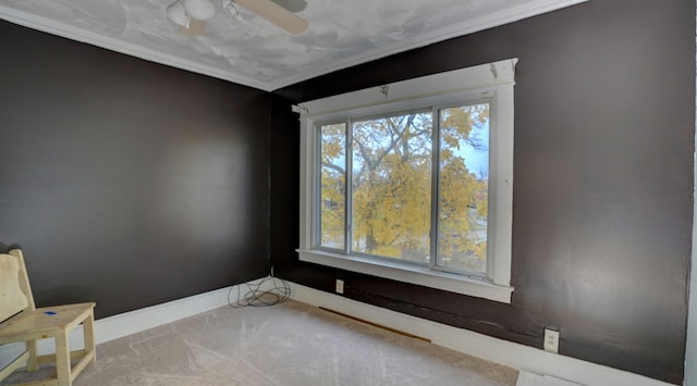 carpeted empty room with a ceiling fan and baseboards