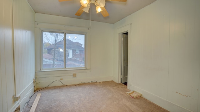 spare room with light carpet and ceiling fan