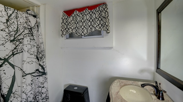 full bathroom featuring curtained shower and a sink