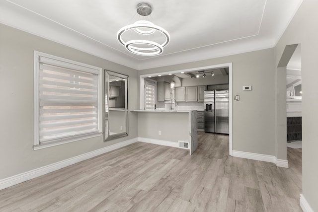 interior space featuring crown molding, light wood-type flooring, sink, and track lighting