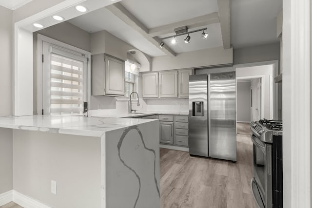 kitchen with gray cabinetry, sink, stainless steel appliances, kitchen peninsula, and light hardwood / wood-style floors