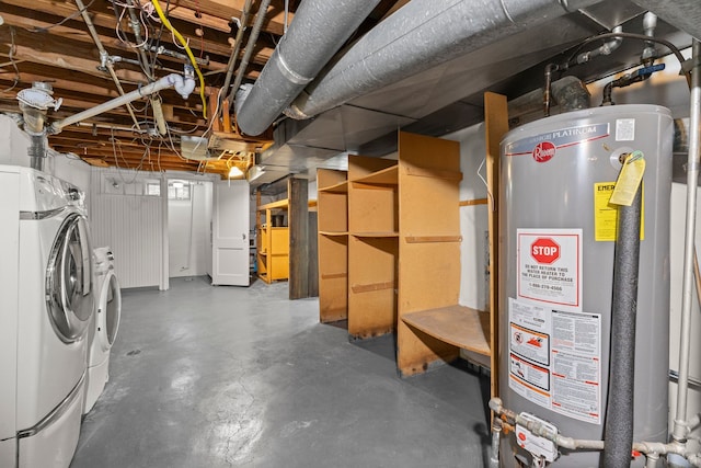 basement with water heater and washer and dryer