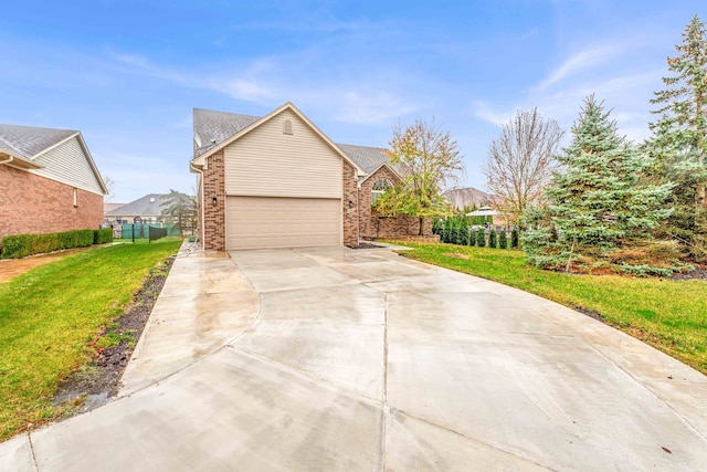 view of front of home featuring a garage and a front lawn