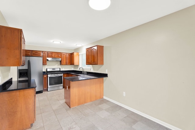 kitchen featuring kitchen peninsula, appliances with stainless steel finishes, and sink