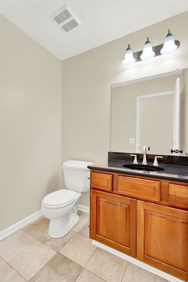 bathroom featuring tile patterned floors, vanity, and toilet