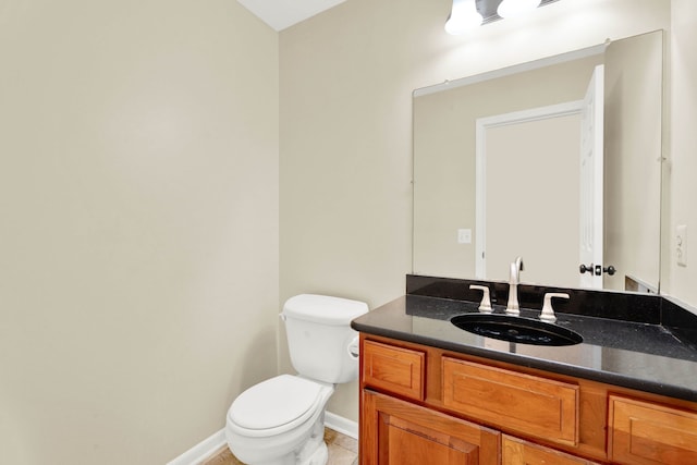 bathroom with tile patterned flooring, vanity, and toilet