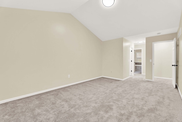 interior space featuring light carpet and lofted ceiling