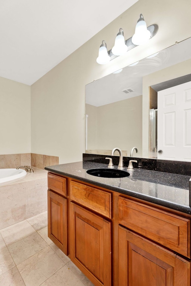 bathroom with vanity and independent shower and bath