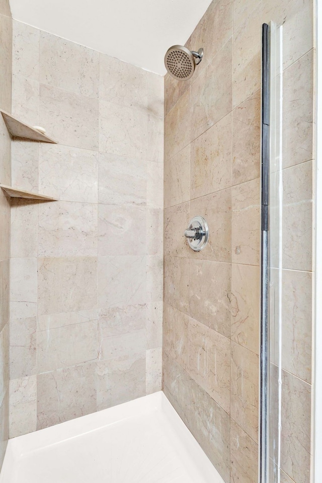 bathroom with a tile shower