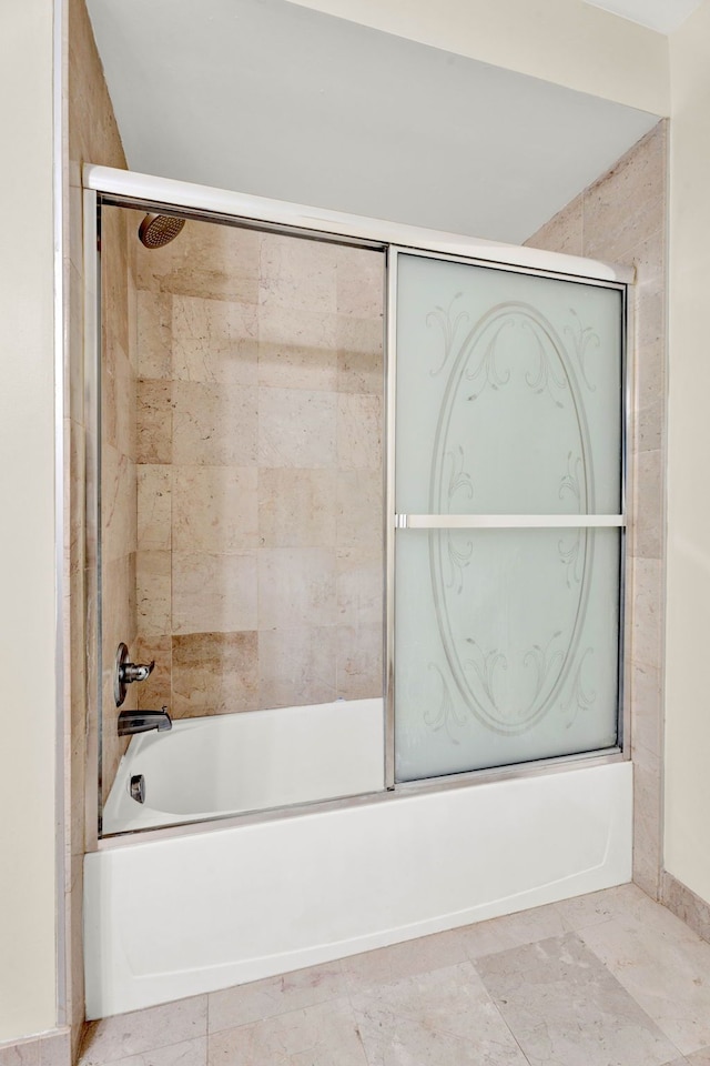 bathroom featuring shower / bath combination with glass door