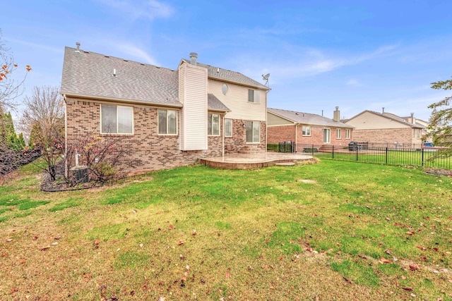 back of property with a lawn and a patio area