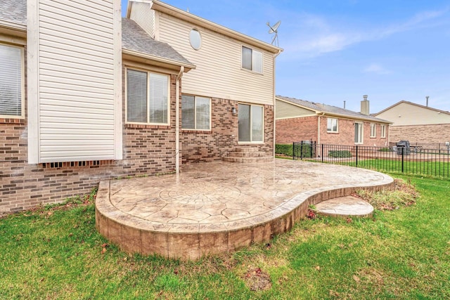 back of property featuring a lawn and a patio area