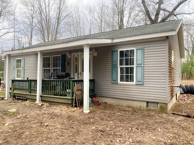 back of property with a porch