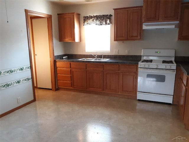 kitchen featuring sink and white gas range oven