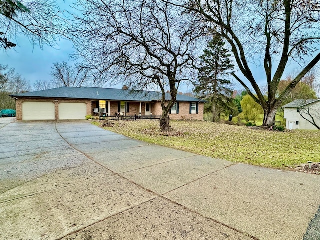 ranch-style home featuring a garage and a front lawn