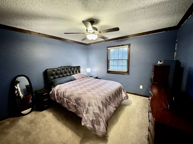 carpeted bedroom with ceiling fan, crown molding, and a textured ceiling