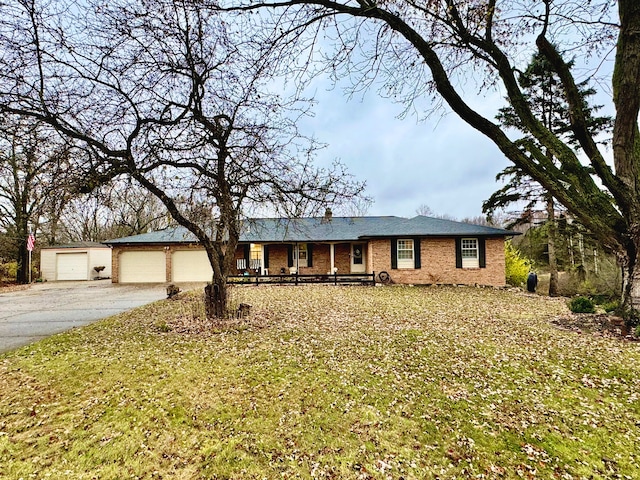 ranch-style home featuring a garage, brick siding, and a front yard