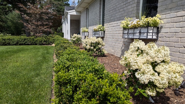 view of side of property with a yard