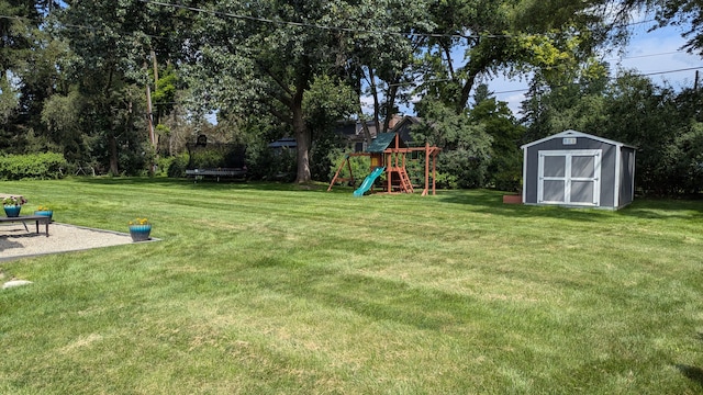 view of yard featuring a shed, a playground, and a trampoline