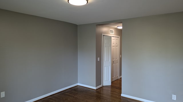 spare room with dark hardwood / wood-style flooring