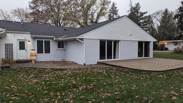 back of house featuring a patio area and a yard