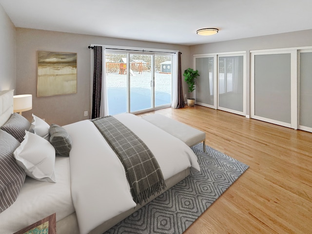 bedroom with hardwood / wood-style floors and access to exterior