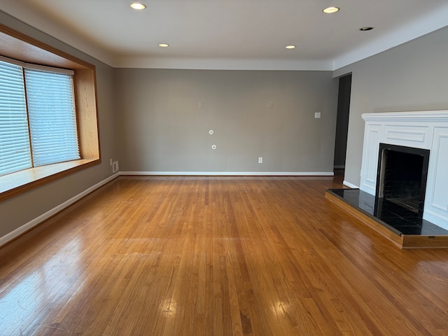 unfurnished living room featuring light hardwood / wood-style floors and a fireplace